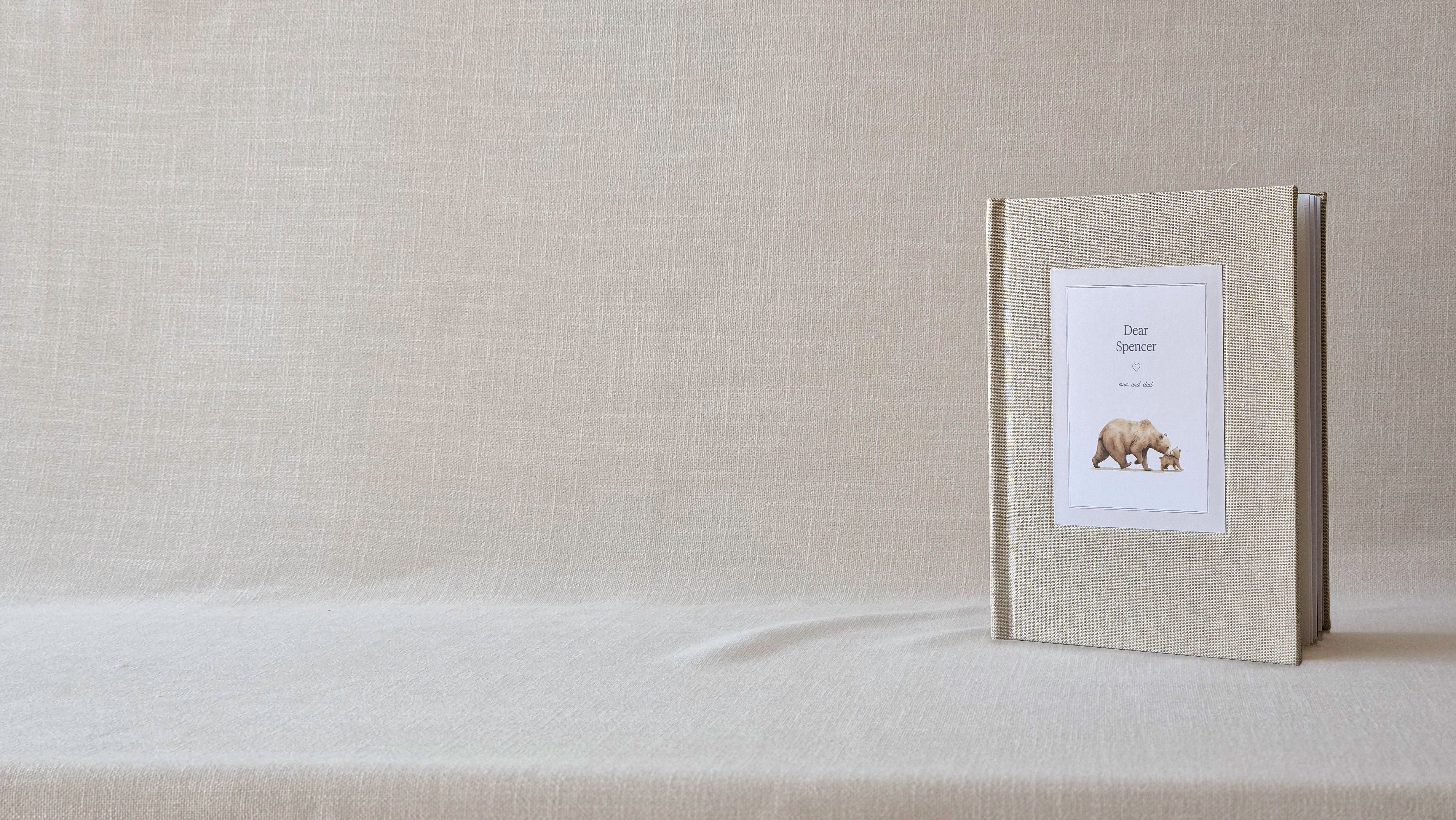 The linen-bound Parent Book standing on soft linen